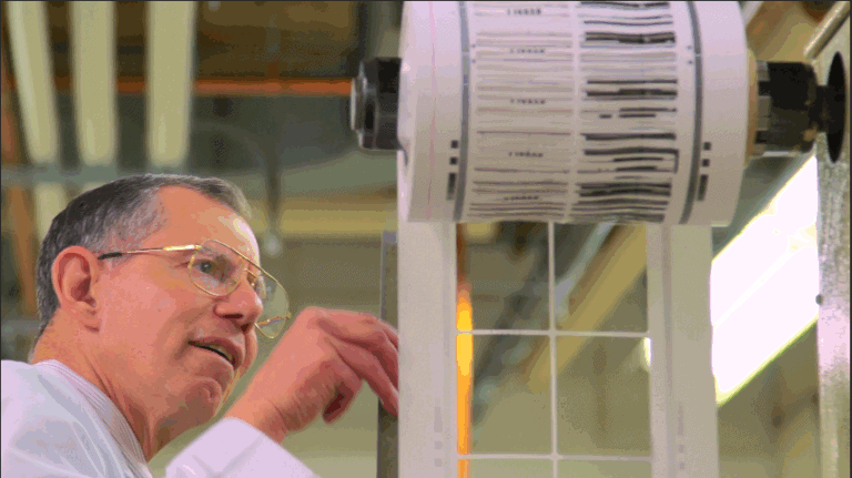 1. Industrial printer printing barcode labels in a manufacturing facility.